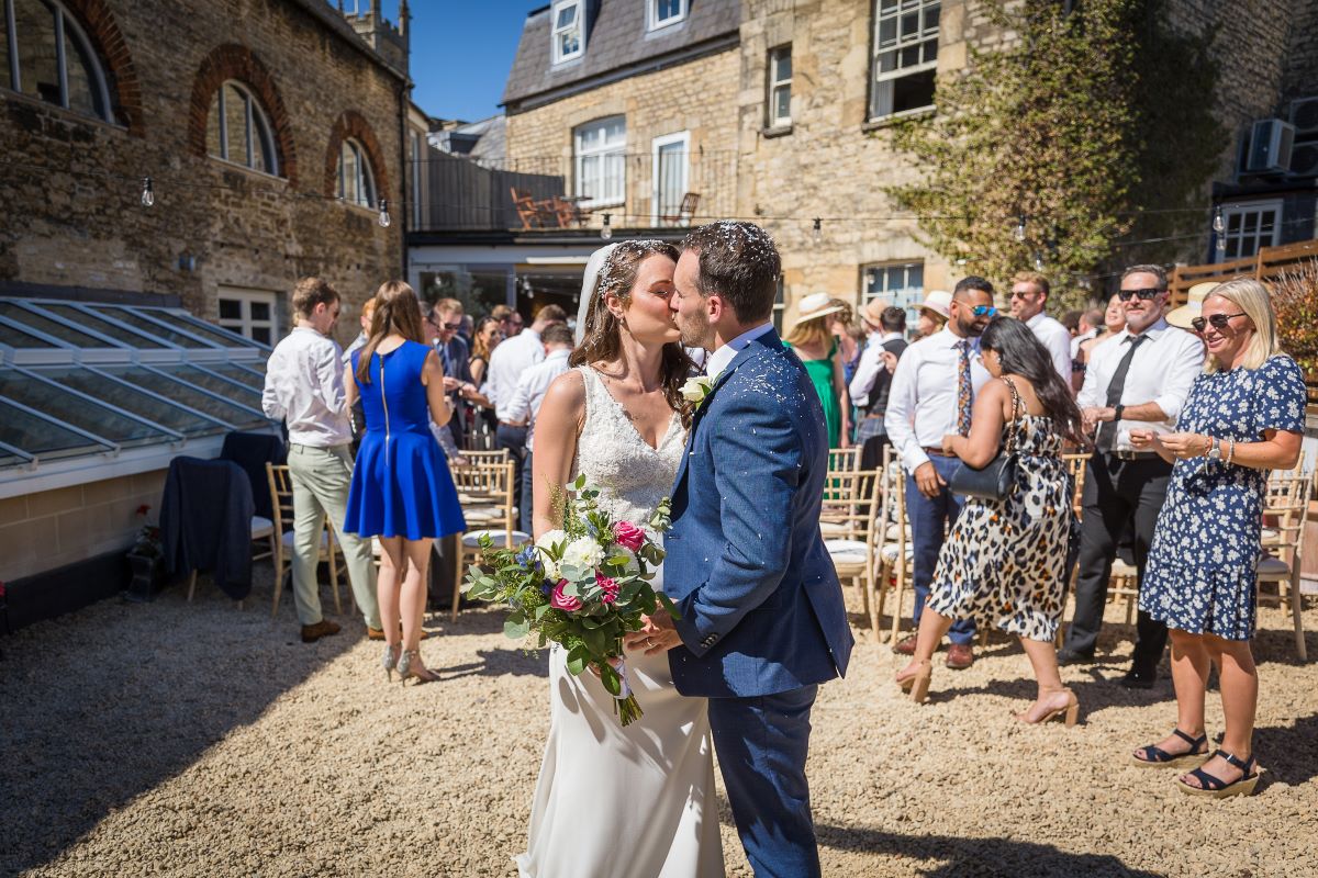Wedding couple kissing on the terrace at Kings Head Cirencester