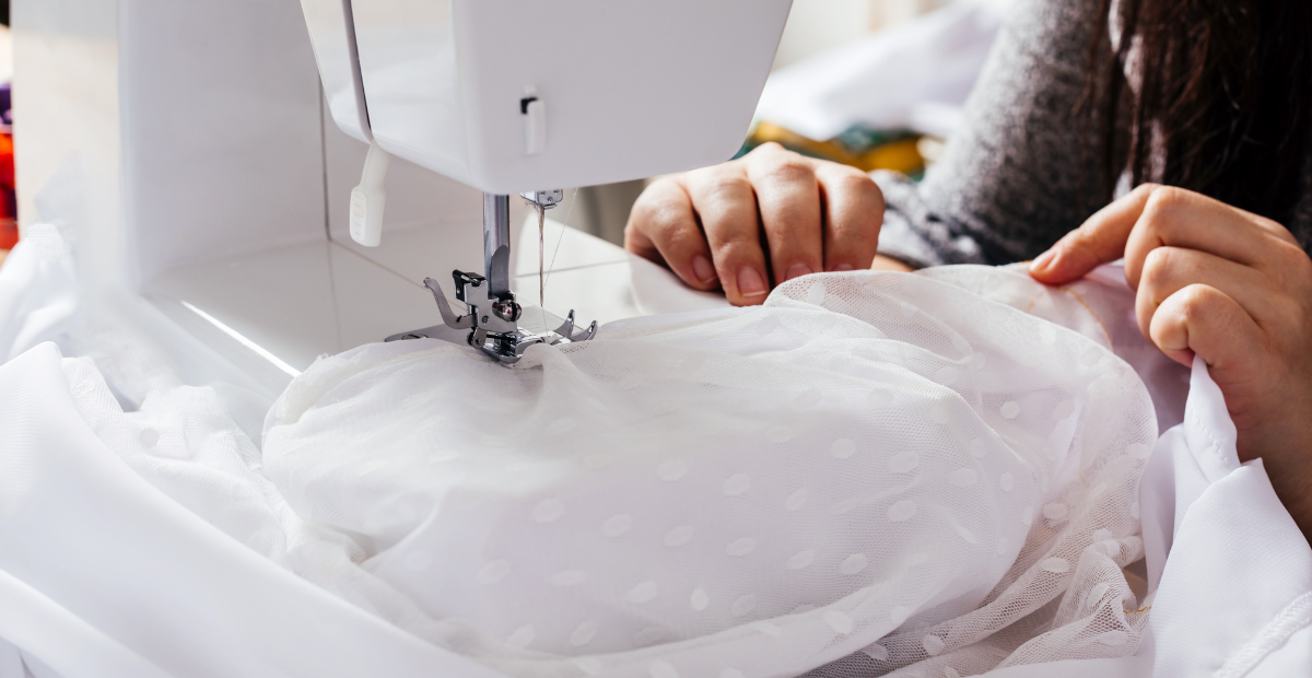 Sewing a wedding dress on a machine 